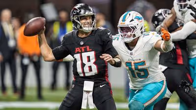 Atlanta Falcons quarterback Kirk Cousins (18) passes under pressure from Miami Dolphins linebacker Jaelan Phillips (15) during the first quarter at Mercedes-Benz Stadium in the 2025 season.